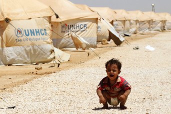 A Syrian refugee child cries at the Al Zaatri refugee camp in the Jordanian city of Mafraq, near the border with Syria